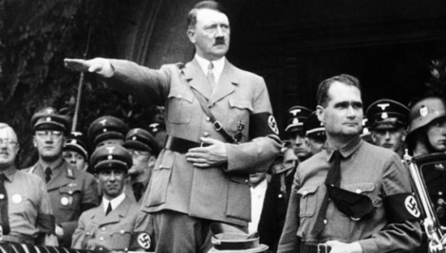 German Chancellor Adolf Hitler and his personal representative Rudolf Hess, right, during a parade in Berlin, Germany, on Dec. 30, 1938. (Photo by AP/Haaretz)